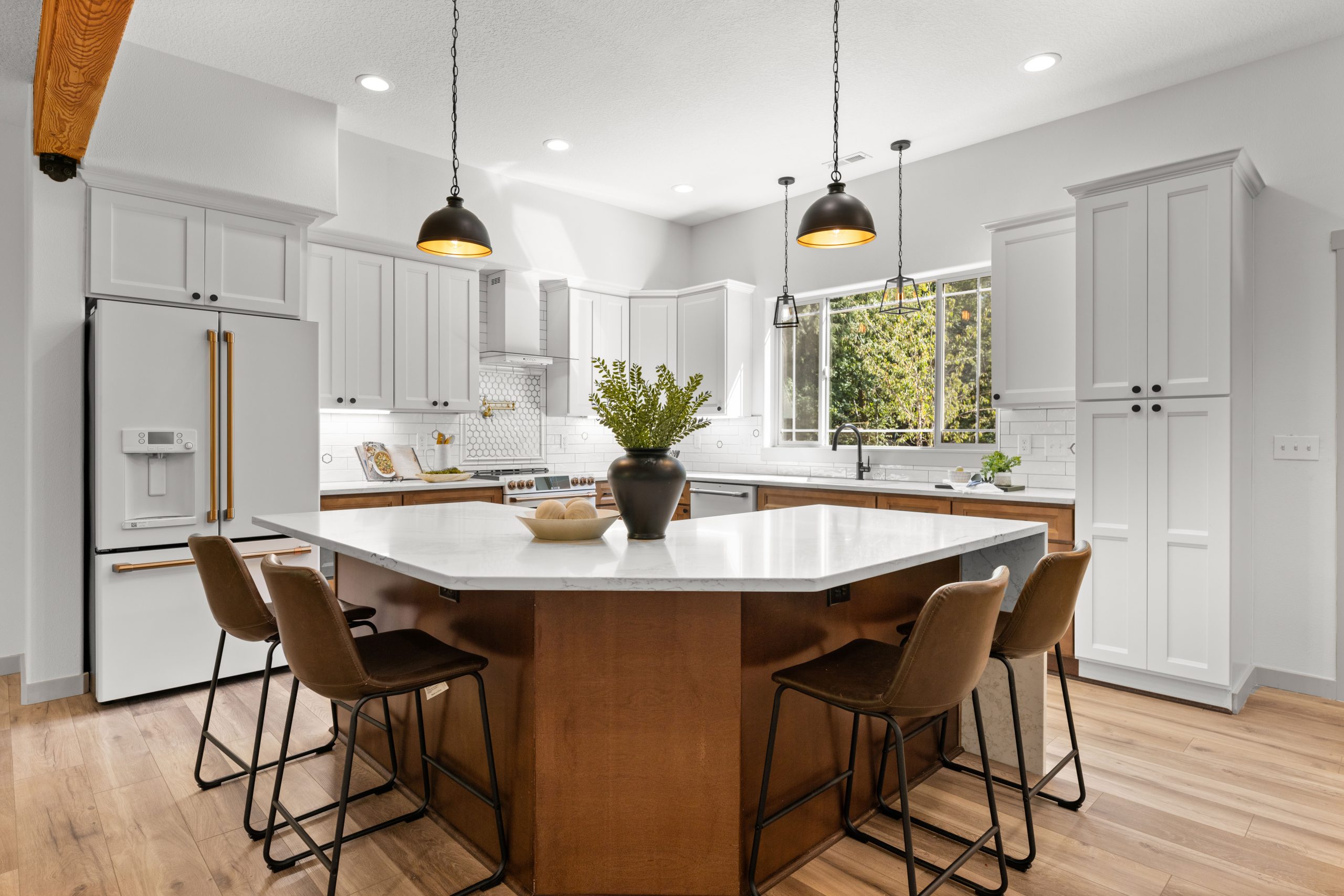 Kitchen island with seating, pendant lighting, and updated cabinetry