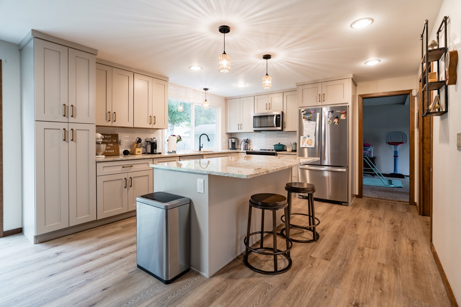 Sarah's remodeled kitchen with white cabinets and an island