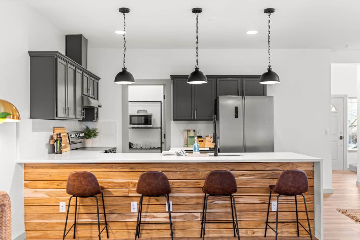 Open kitchen remodel with island seating by Hammer Falls Construction